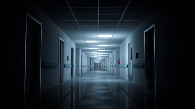 Hospital corridor with few lights on. 3d rendering. Seamless looping. (via Getty images)