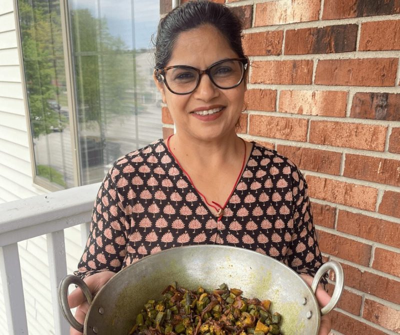 Author's mother holding homemade Bhindi Masala