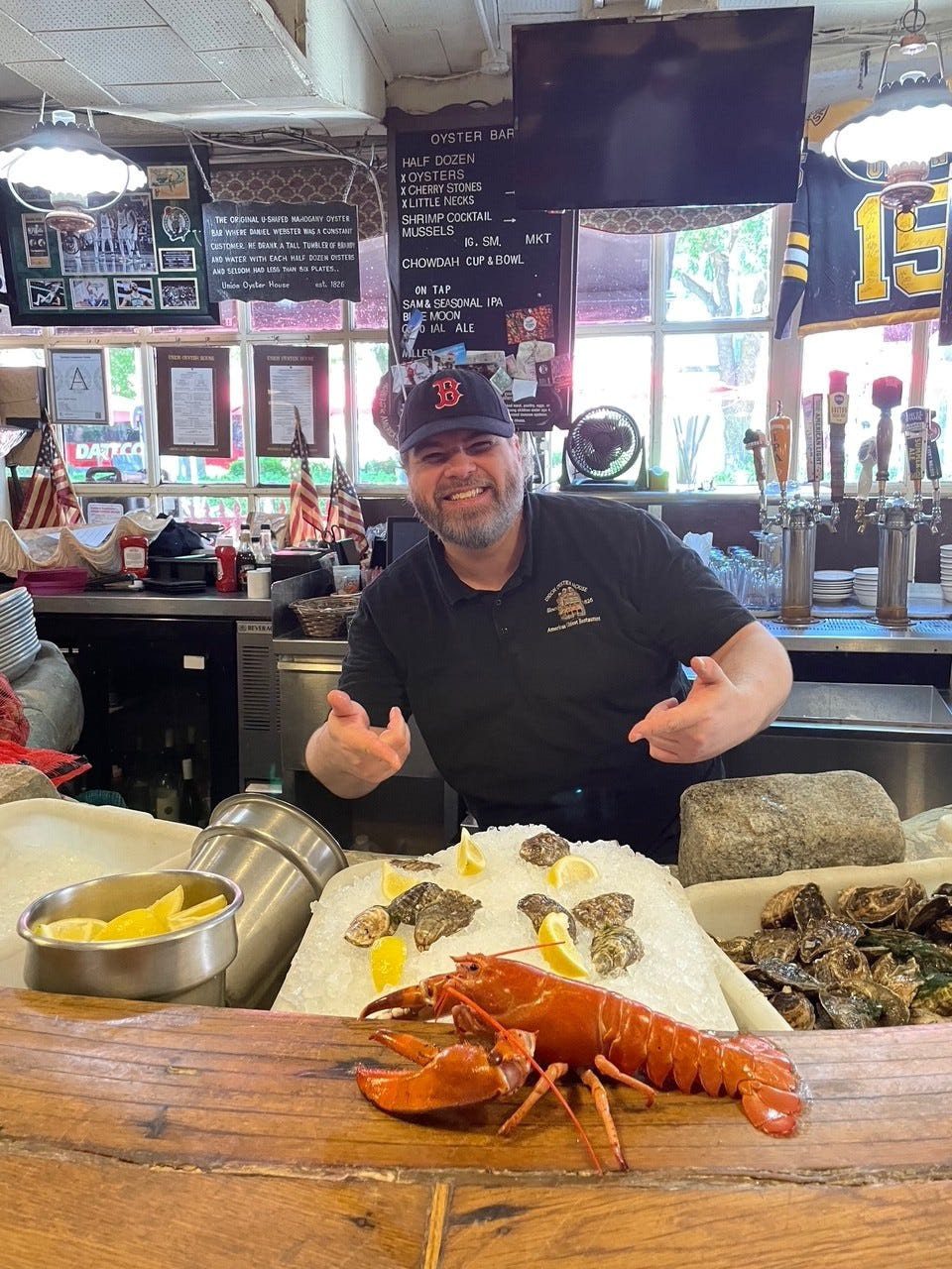 A man poses with the orange lobster